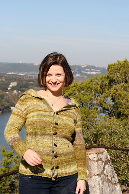 Christina smiling in her handspun, handknit cardigan.