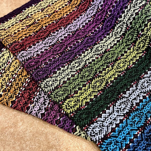 richly textured striped woven pieces in deep jewel tones