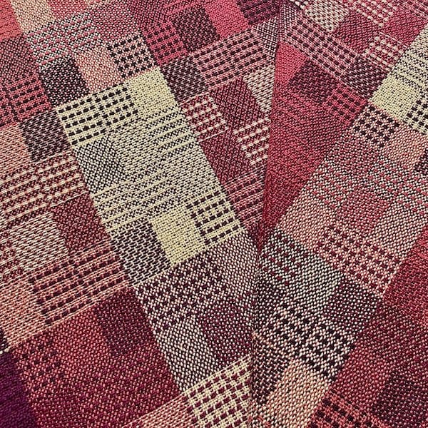woven checkered tea towels in rich pinks, maroons, and cream